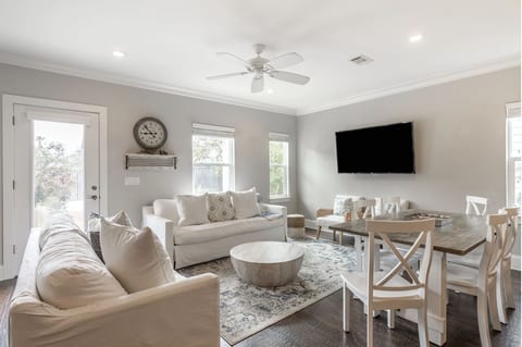 Living room features a sleeper sofa and 50 inch TV