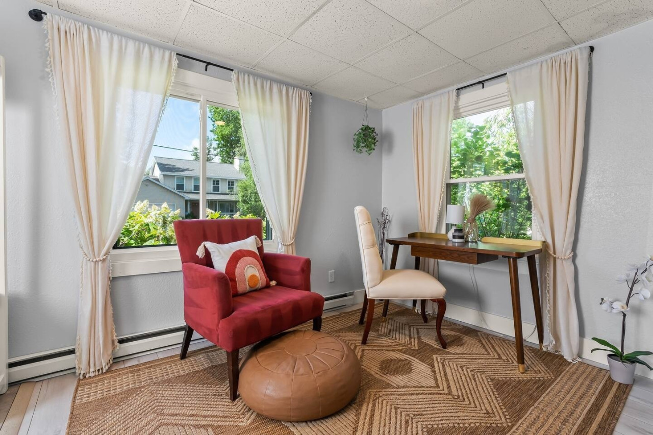 Perfect for work or relaxation, this cozy space features a desk, comfortable chair, and a single couch, ideal for getting things done or unwinding.