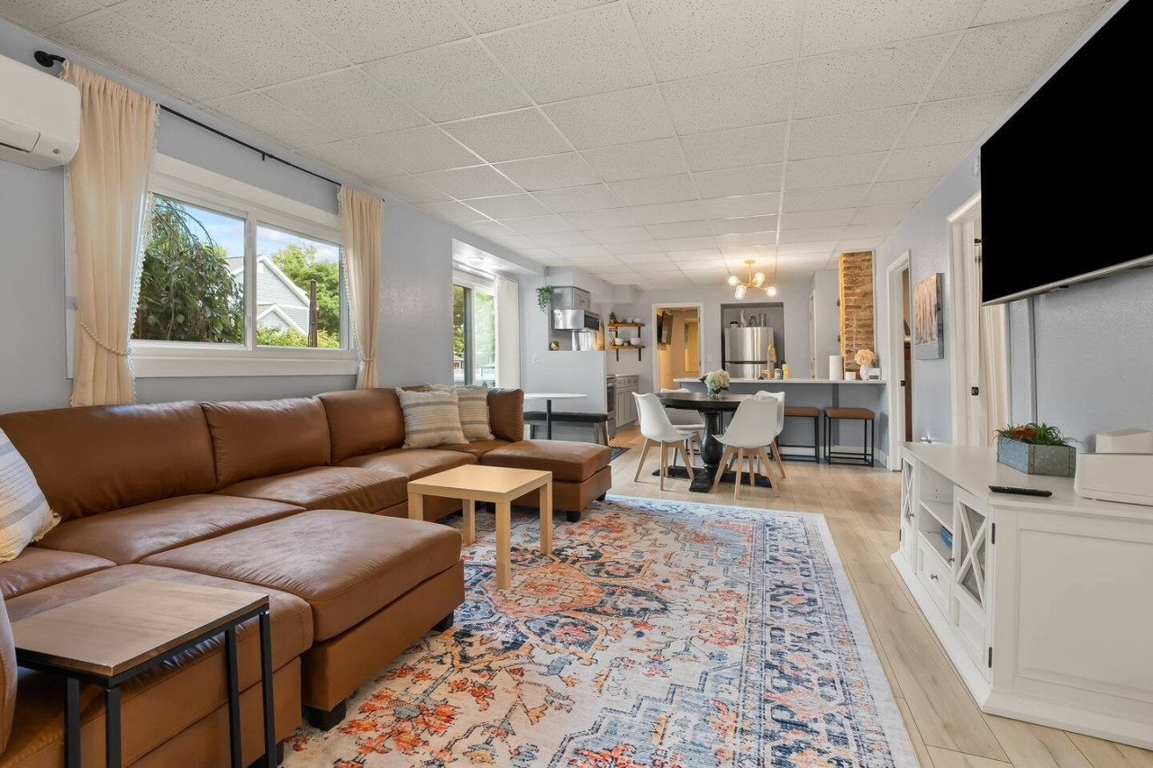 Relax in the spacious living room with a comfy couch and smart TV, the perfect spot to unwind after a day of adventures.