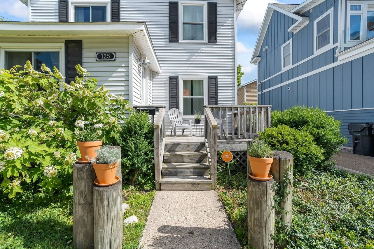 Welcome home! The front porch invites you to relax and unwind, offering a cozy spot to enjoy the fresh air and the start of your perfect getaway