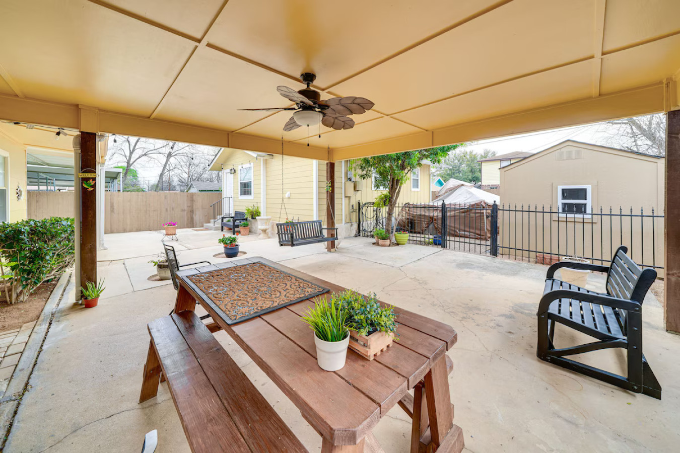 Welcome to Chic San Antonio Cottage! Enjoy the covered patio with a picnic table and swing chair, perfect for relaxing mornings or peaceful evenings.