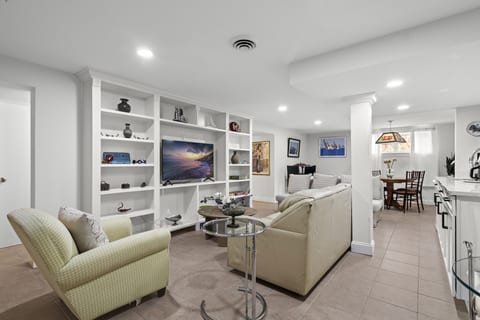 "Relax and recharge in the cozy living room, featuring a full sleeper sofa and Smart TV for a comfortable stay.