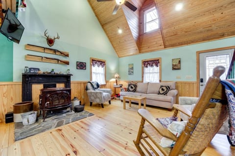 Cozy up in the inviting living room, complete with a warm wood-burning stove—the perfect spot to relax after a day of lake adventures!