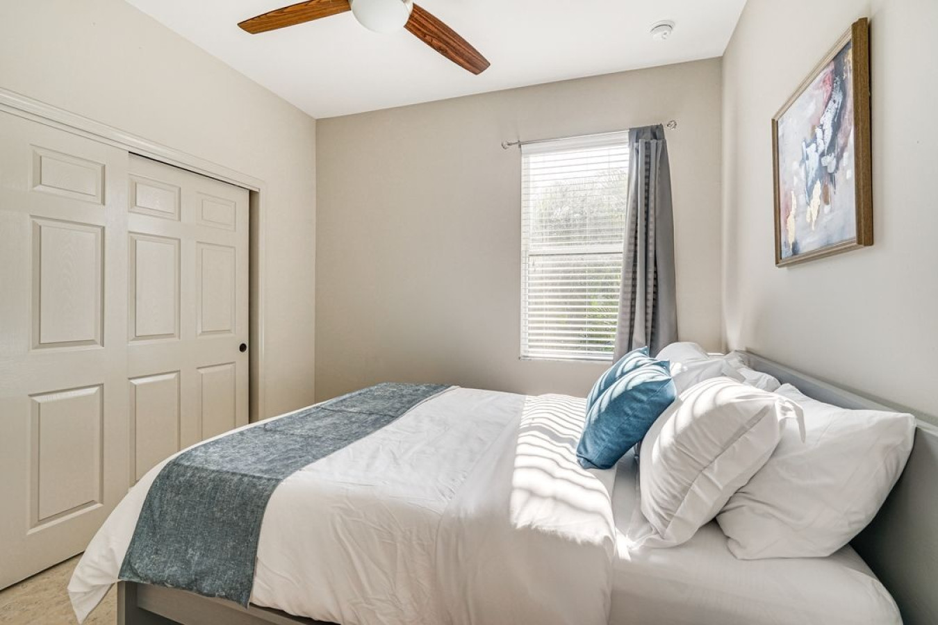 Soft sunlight fills this comfortable bedroom, creating a relaxing atmosphere.