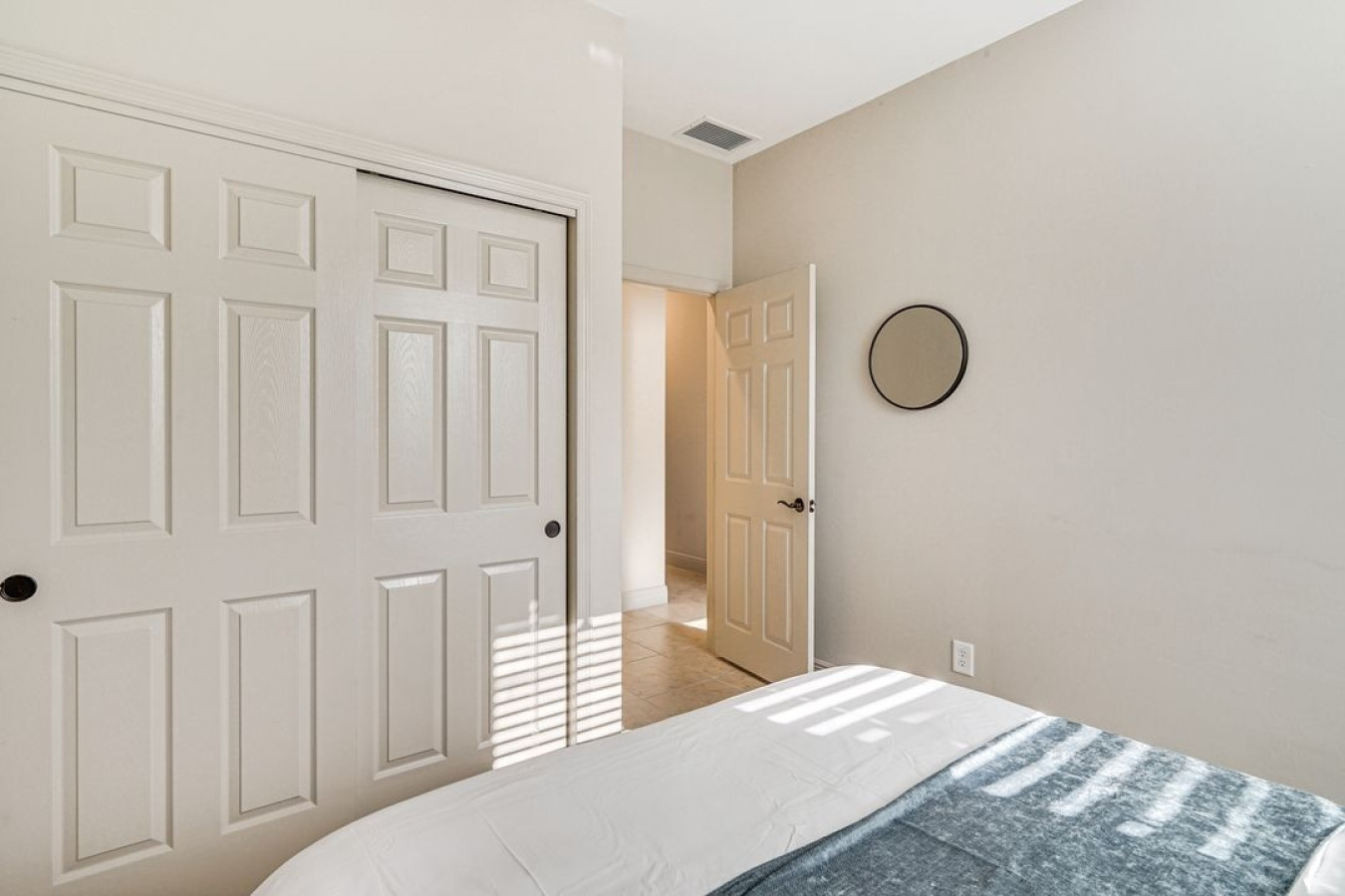 Relax and recharge in this sunlit bedroom, designed for comfort and ease.