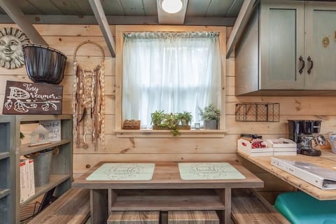 Dining area. This table can be used for a work desk, a quaint breakfast of coffee and eggs, or pull it out into a 4 seater. The counter flips down for more space.