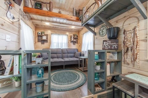 Living Room with futon/couch/bed that pulls out into a full size sleeper. Tv on the wall, large 3'x3' windows