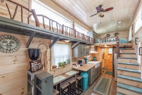 Kitchen with fold out table, flip down counter, farm house sink, electric cooktop burner with ventilation