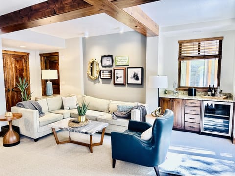 Stylish living room with fireplace, bar area and dining for 10. Open floorpan is great for gathering and relaxing.
