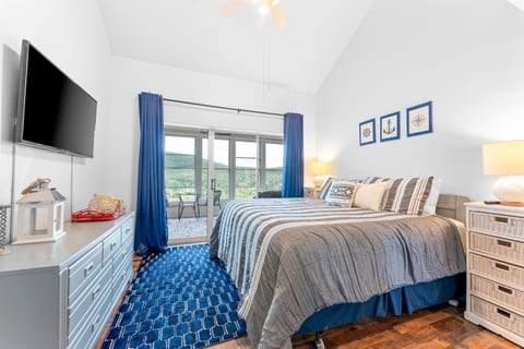 Wake up to scenic views of the Ozark Mountains in the master bedroom, with direct access to the serene sunroom.