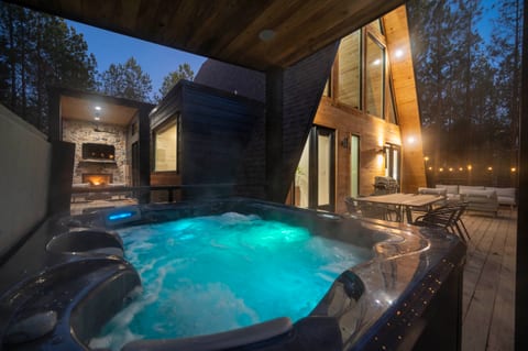 Relax in the hot tub while gazing at the stars, or watching the fire and a late-night movie
