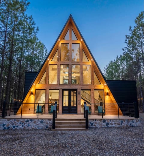 "Embrace the serenity: Our A-frame cabin, where modern design meets the rustic charm of the forest."