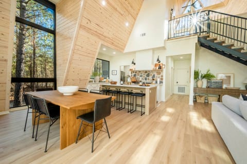 "Let the sunlight flood in through large windows, illuminating the beauty of natural wood and contemporary design."