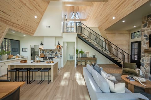 "Be captivated by the high ceilings and warm ambiance of our A-frame cabin, where every detail is a testament to craftsmanship."