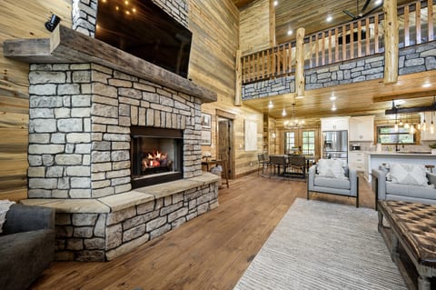 "Cozy up in style with a backdrop of flickering flames from our historic wood mantle fireplace."