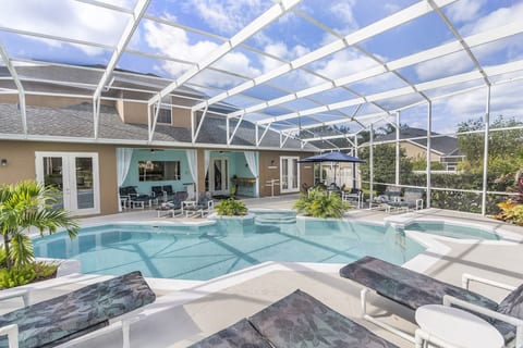 Mickey's Oyster 9 Bedroom 8 Bathroom Sleeps 18 People 2 Miles to Disney Gorgeous large tropical pool area with spa, surrounded by palm trees and shrubs.