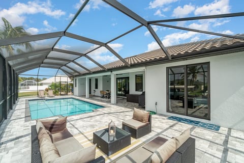 Enjoy the canal-front view from the private heated pool, covered lanai, & outdoor furniture.