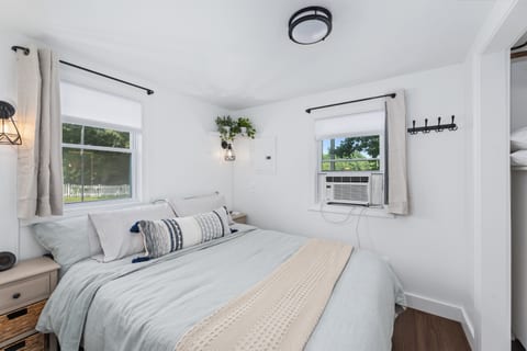 Bedroom with Queen bed, luxury linens, insulated blinds and blackout cr