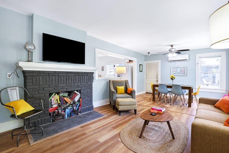 Living room seating, TV, and dining room