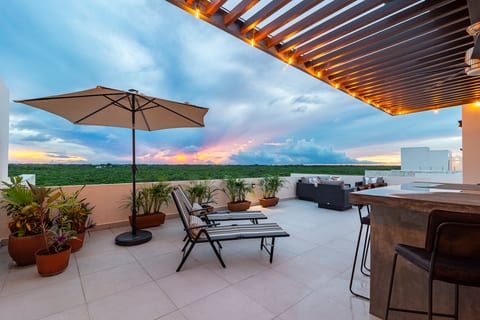 Enjoy sunsets from private rooftop patio