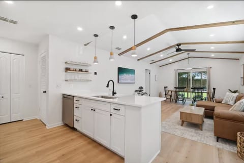 Open concept kitchen and living room to host your group in.