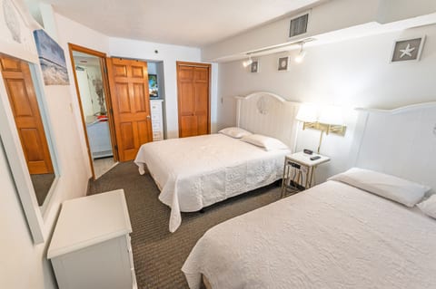 - A serene bedroom with warm wooden tones, soft lighting, and plush bedding - A perfect fusion of comfort and coastal charm, designed for restful nights and peaceful mornings - Relax, unwind, and drift off to sleep in this cozy coastal retreat