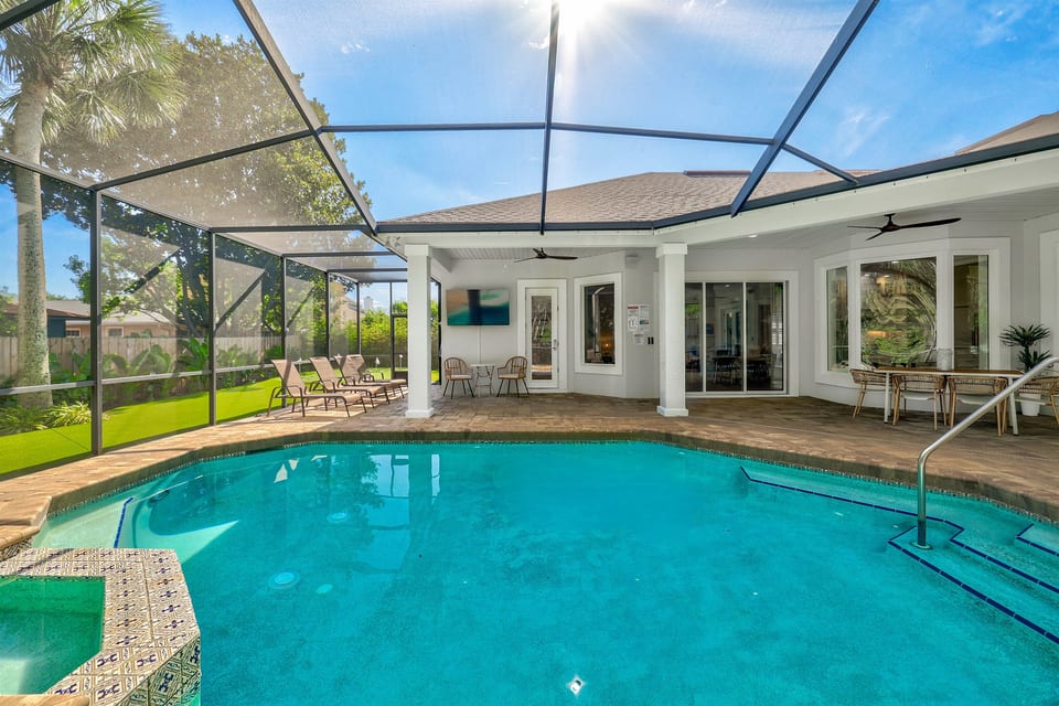 Heated pool and spa within a private screened enclosure for year-round relaxation