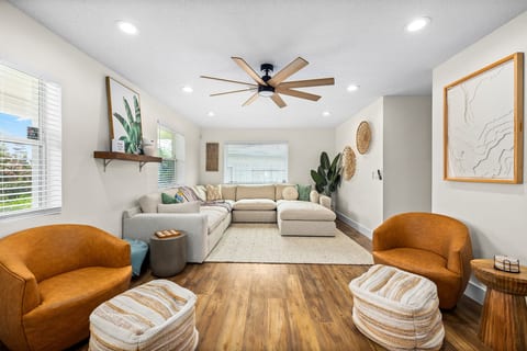 Unwind in this beautifully styled living room with plush sectional seating, cozy accent chairs, and a calm coastal atmosphere - perfect after a day at the beach.