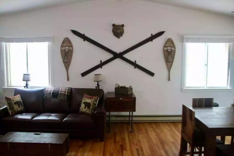 Living room wall shows vintage winter sports decor
