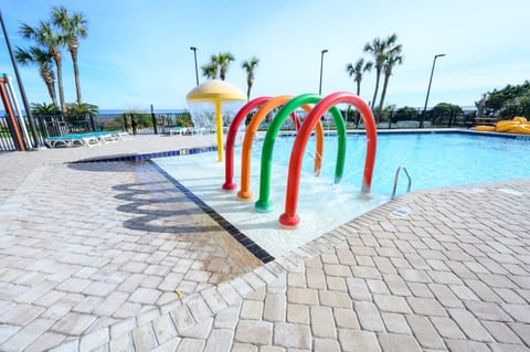 Kids splash area at pool by ocean