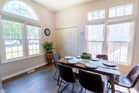 This charming dining space is perfect for gatherings with family or friends. The elegant dining table comfortably seats six guests, offering ample space for meals, games, or shared moments