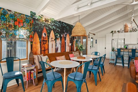 Colorful dining area w/ playful decor, statement lighting & a relaxed spot to gather over meals.