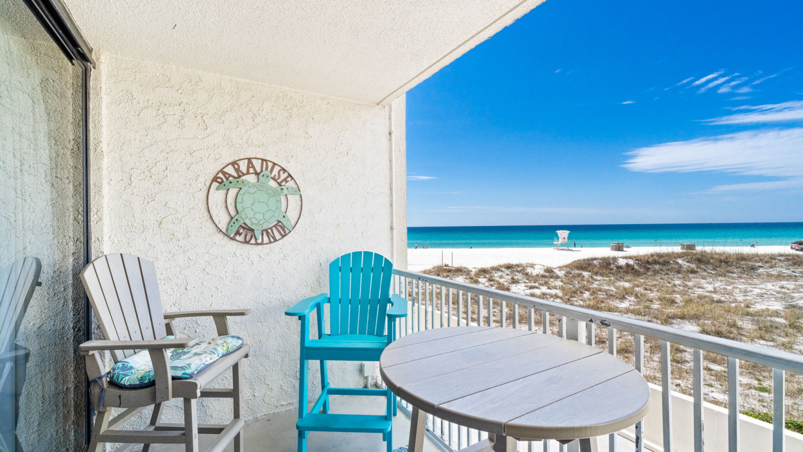 This private beachfront balcony offers cozy seating and panoramic views of the sugar-white sand and emerald waters.