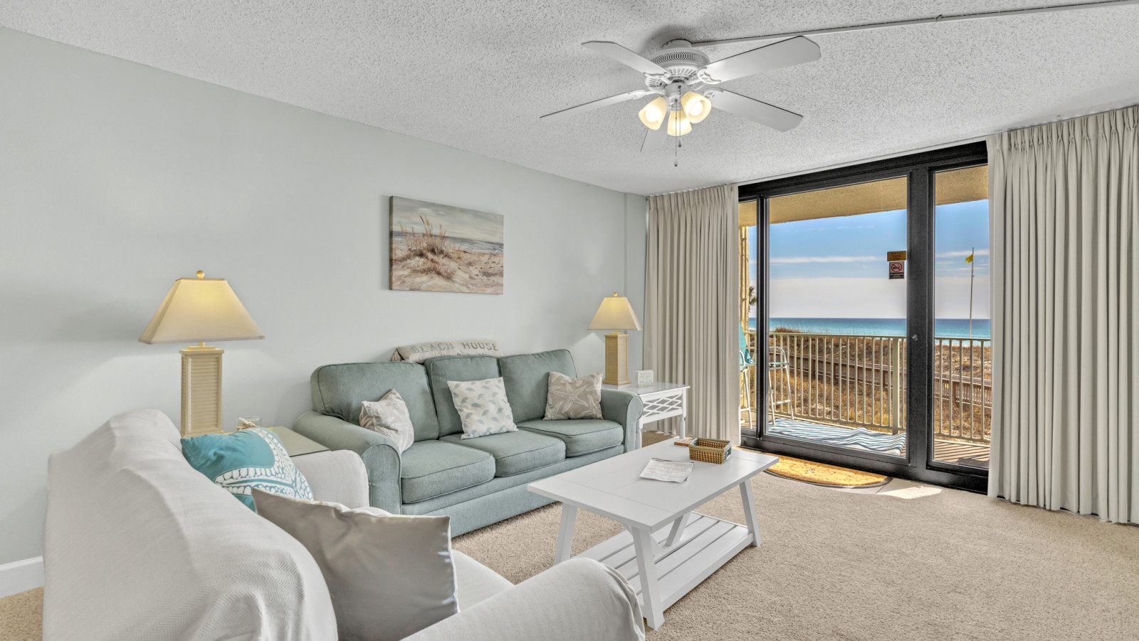 Enjoy stunning Gulf views from a bright living room that opens to a private beachfront balcony with plush seating.