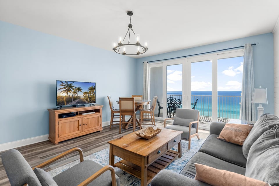 Unwind in the inviting living area featuring a queen-size sleeper sofa, cozy seating, and breathtaking ocean views from the private balcony