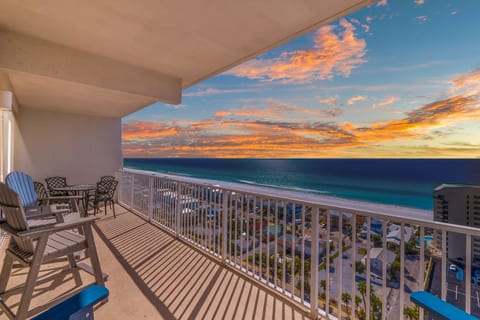 Enjoy breathtaking sunsets and panoramic ocean views from the spacious private balcony, complete with comfortable seating and a dining area