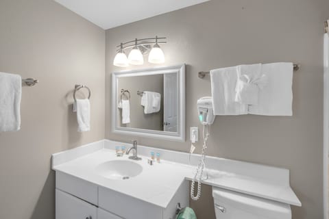 Full bathroom with shower and an in-unit washer and dryer for convenience.