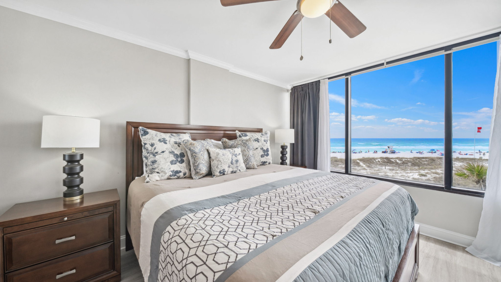 Wake up to stunning Gulf views in this elegant beachfront bedroom with a plush king bed and floor-to-ceiling windows.
