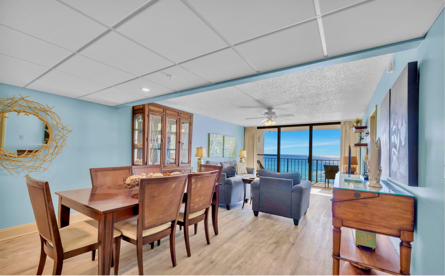 Relax in this spacious, beautifully designed living and dining area with stunning ocean views and an open, airy feel at Edgewater Beach and Golf Resort.