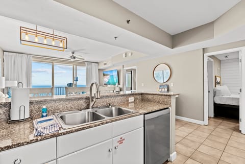 Cook with a view — open-concept kitchen overlooks the living area and Gulf-front balcony.