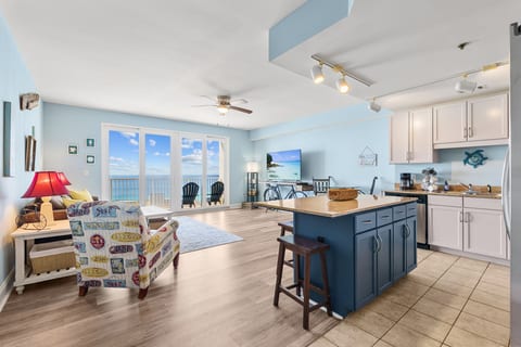 Spacious living area with stunning ocean views and vibrant coastal decor