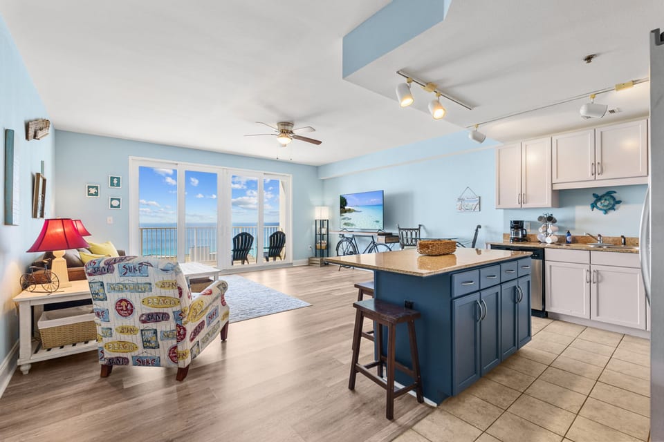 Spacious living area with stunning ocean views and vibrant coastal decor