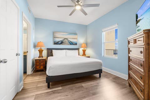 elegant primary bedroom featuring a plush king-size bed and soothing ocean-inspired decor