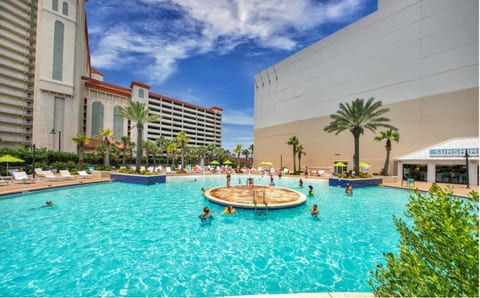 Spacious main resort pool area with lush landscaping and plenty of seating