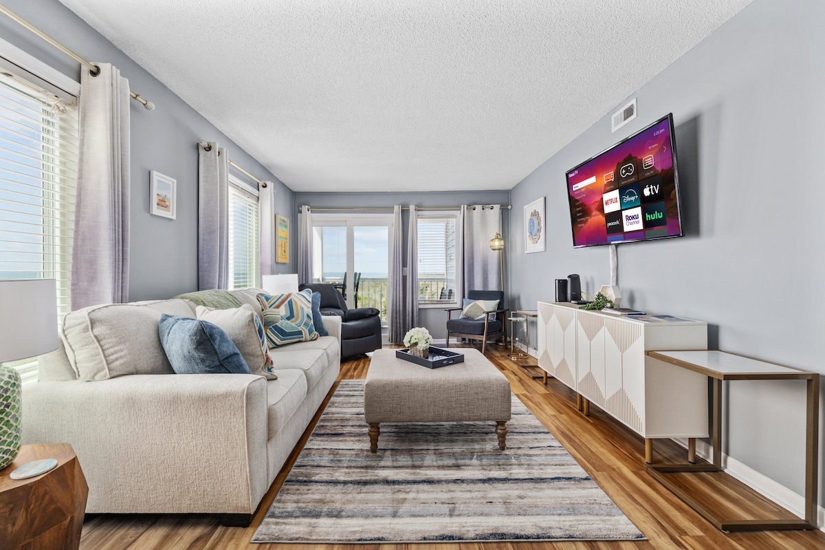 Cozy living room with smart tv, recliner, and fantastic views of the ocean