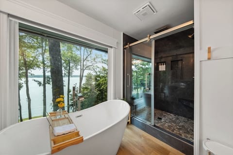Enjoy panoramic views from the soaking tub as it overlooks the serene lake. Relax in the stone two-person shower, unwind at his and her sinks, and step onto your private balcony for fresh air and breathtaking scenery.  