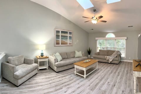 Spacious living room area with vaulted ceiling and sunny skylights! Brand new queen pull-out sleeper sofa has replaced couch