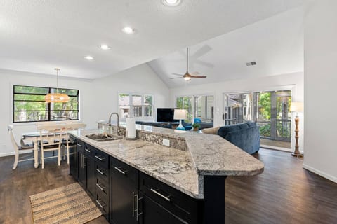 Open concept living and dining area with vaulted ceilings makes for the perfect space for gathering with loved ones/friends on vacation!