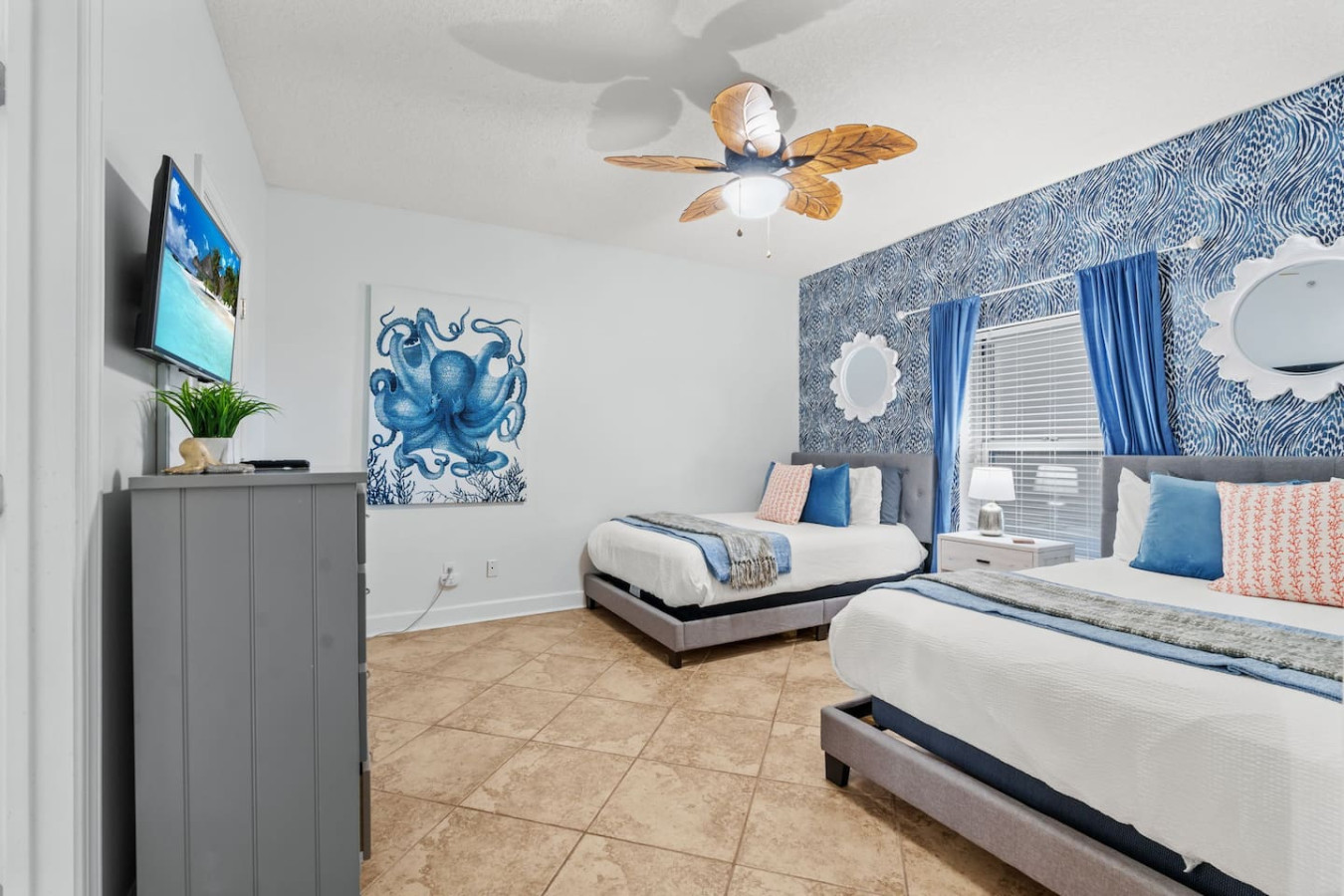 Unwind in this stylish coastal-themed bedroom featuring two comfortable full beds, vibrant ocean-inspired decor, and all the comforts needed for a relaxing beach getaway