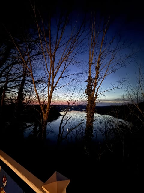 Twilight horizon views from a private, wooded deck—serene escape.